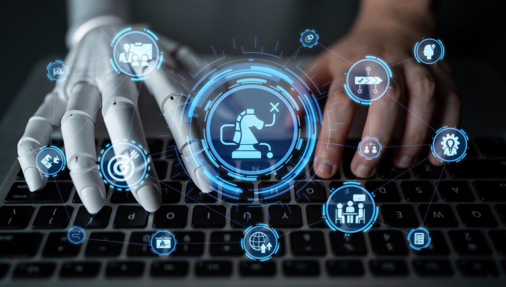 An image of a human left hand and a robot right hand typing on a computer keyboard to signify a human Business virtual assistant